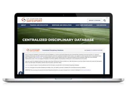 Laptop with Centralized Disciplinary Database webpage on screen
